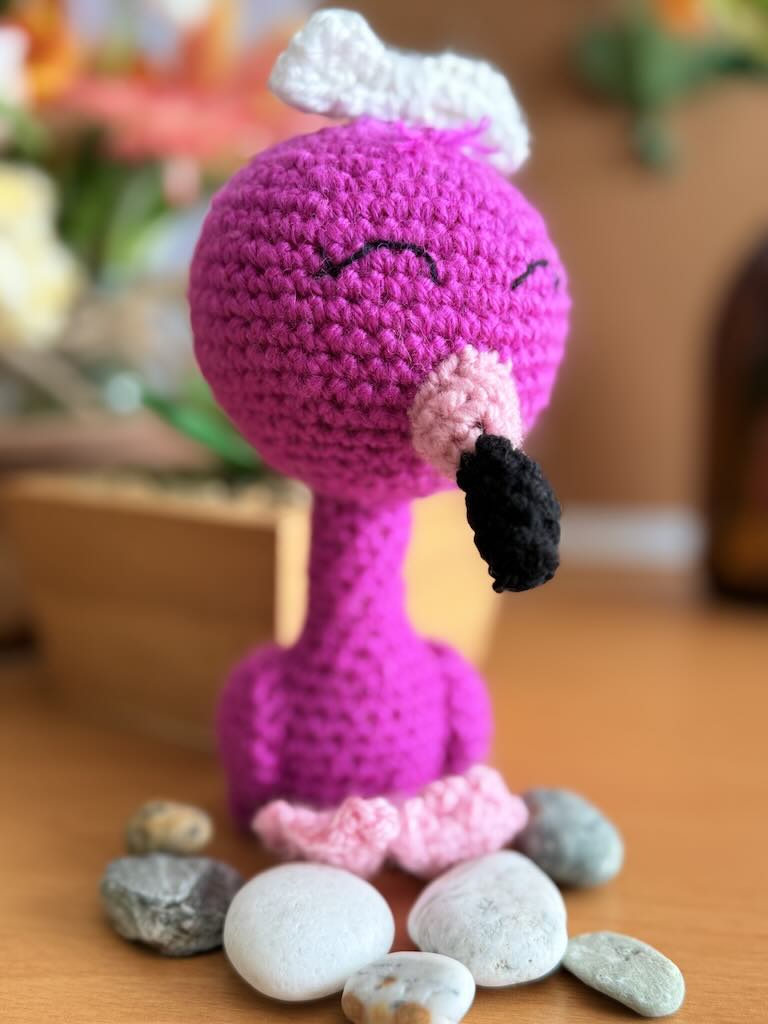 handmade crochet flamingo with pink yarn, long legs, and curved neck