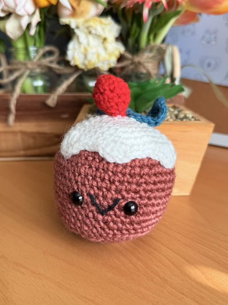 crochet christmas cake toy with festive decorations and colorful yarn
