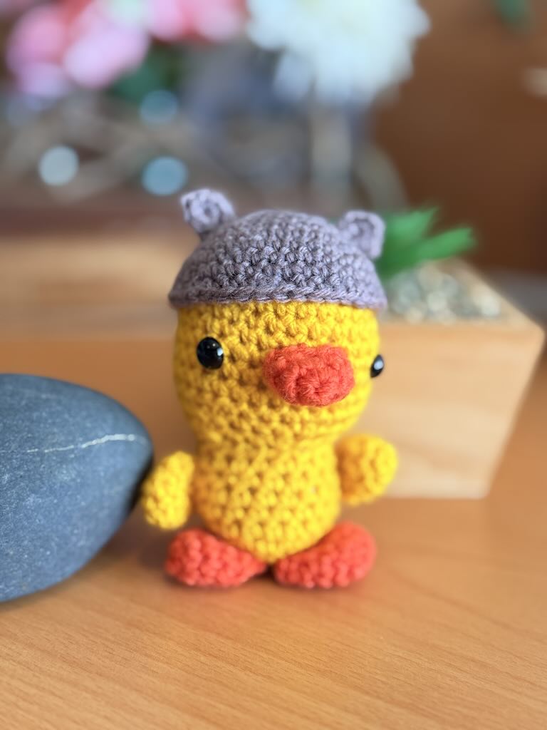 crochet duck toy masquerading as a bear with soft body and playful look