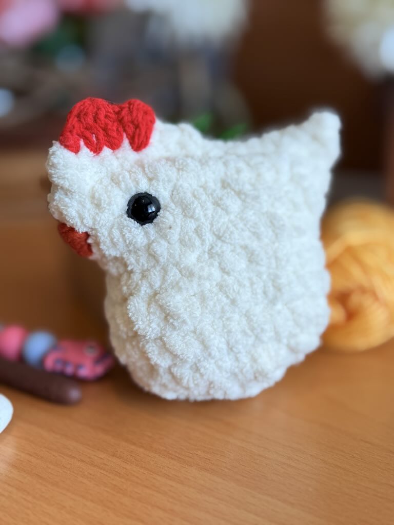 handmade white crochet chicken with soft feathers and bright comb