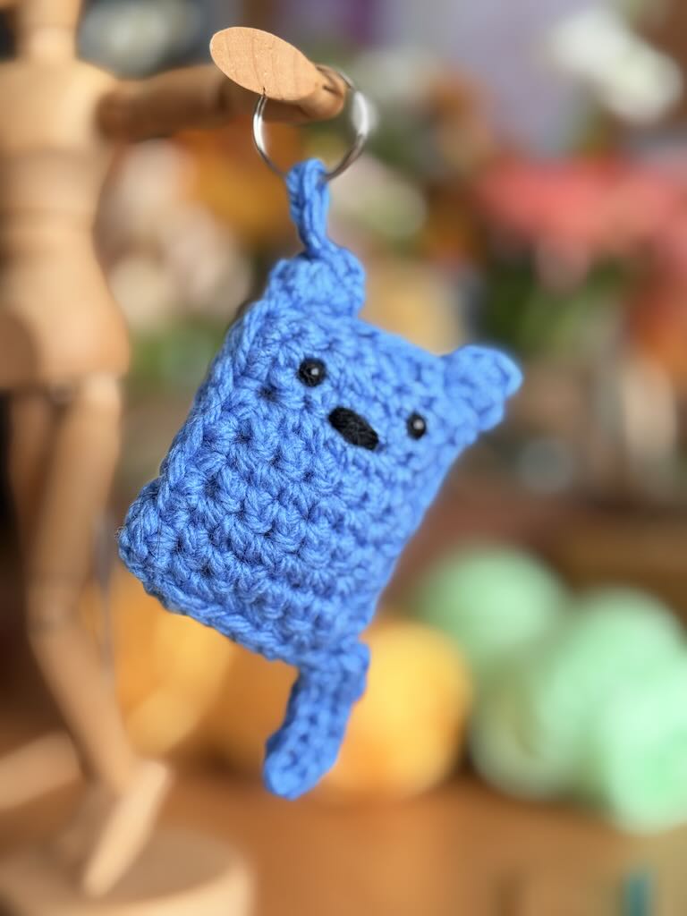 handmade keychain crochet blue cat with playful expression
