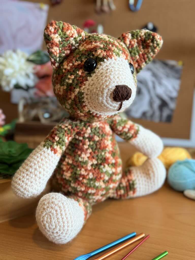 handmade colorful crochet cat named Cory with playful expression