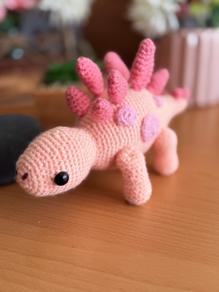 handmade crochet stegosaurus dinosaur toy named Simon with plated back