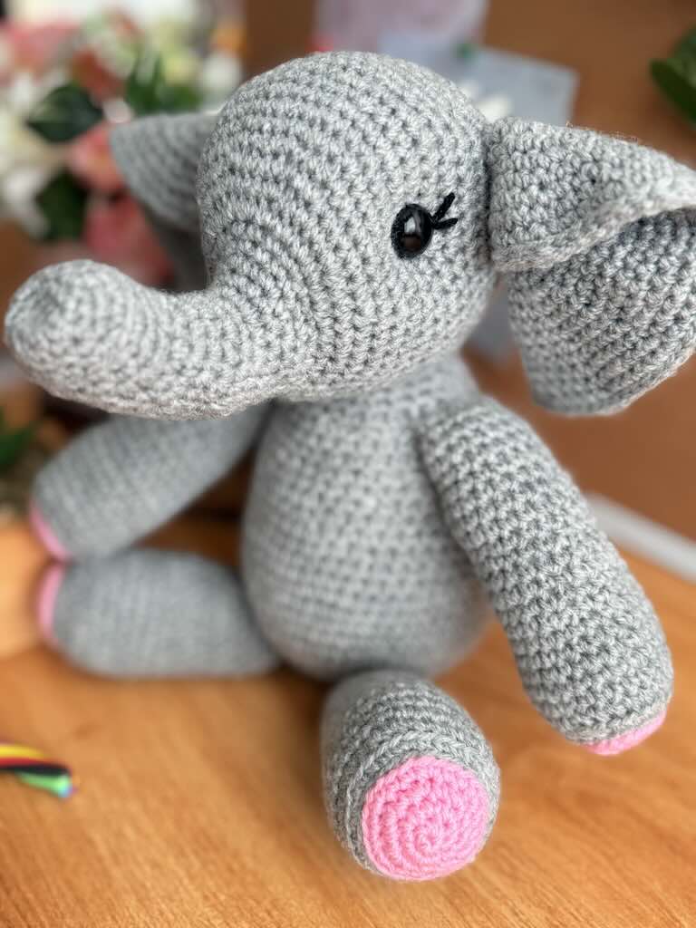 handmade crochet elephant toy named Ellie with big ears and pink feet