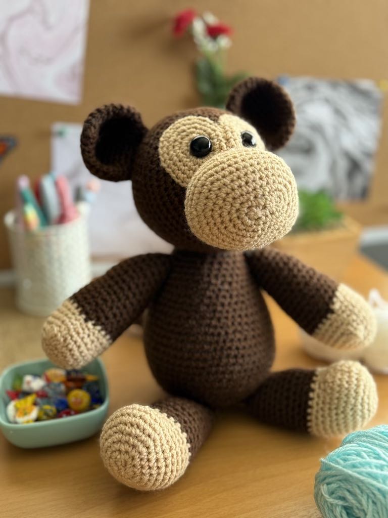 handmade crochet monkey toy named Minkie with soft brown yarn