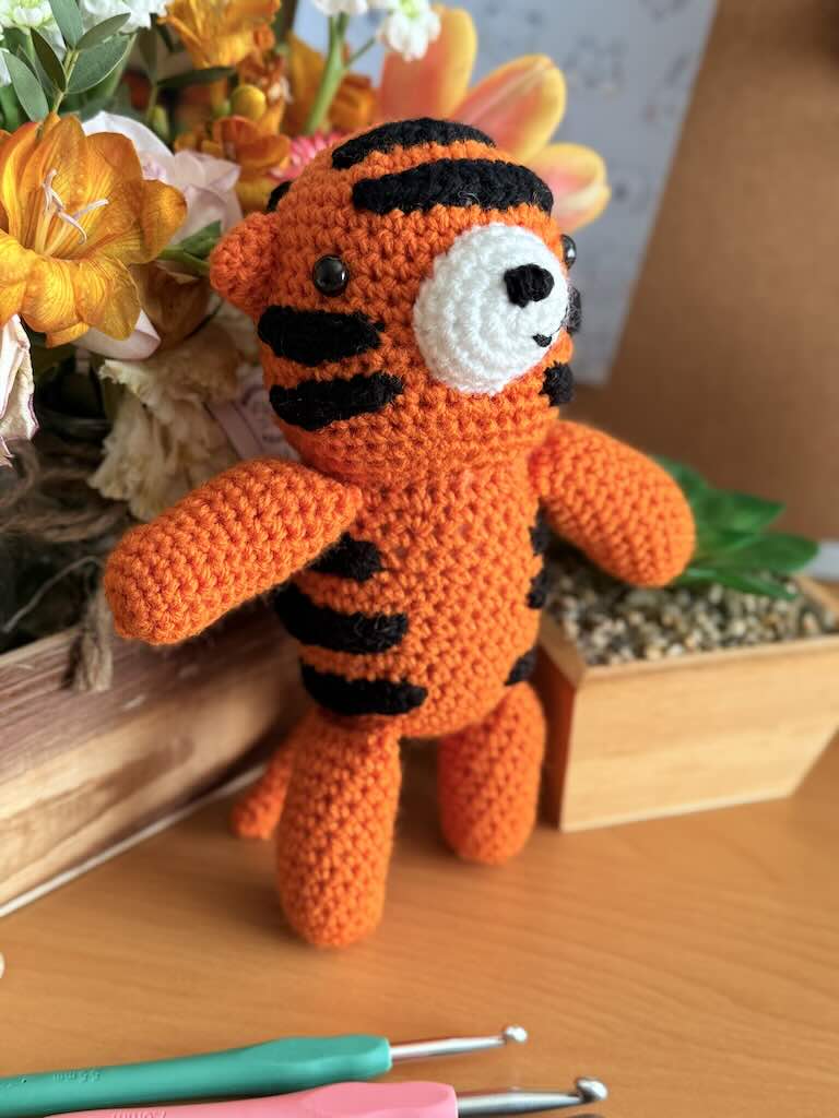 handmade crochet tiger toy named Zee with bright orange stripes